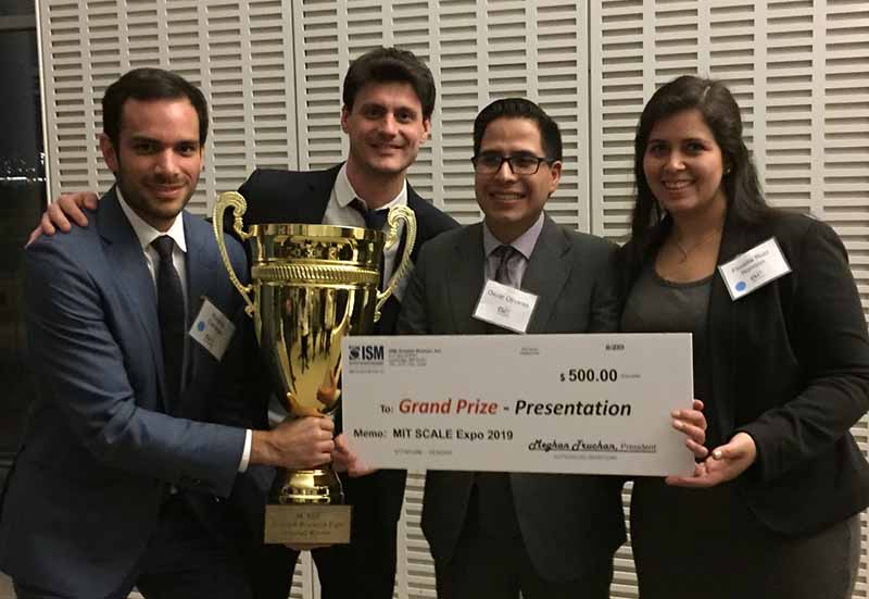 An MS in Energy Systems student accepts an award with his group.