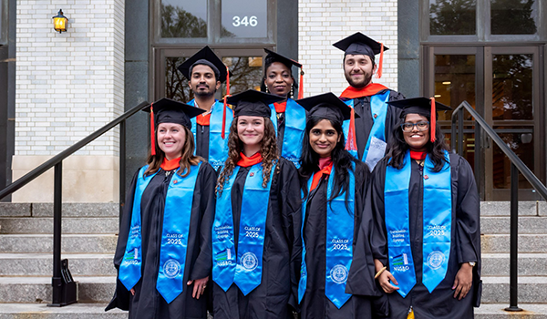sowpamini ponnada with NUSBO leaders in graduation attire