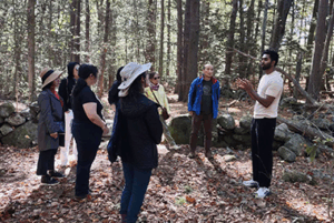 Subash Rajaseelan speaking about AI in the woods to a group of people