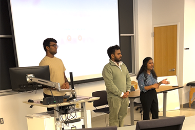 3 students presenting in a classroom
